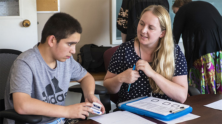 student works with patient